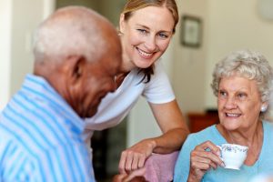 A caregiver talks with a couple